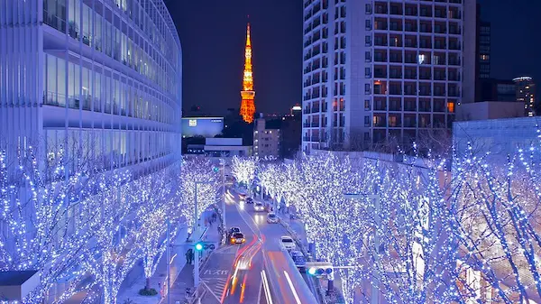 Streets near Tokyo Tower shining with intricate, glowing lights and festive displays.