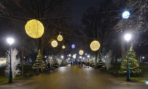 The Champs de Mars park glowing with festive lights, offering a magical view of the Eiffel Tower during Christmas.